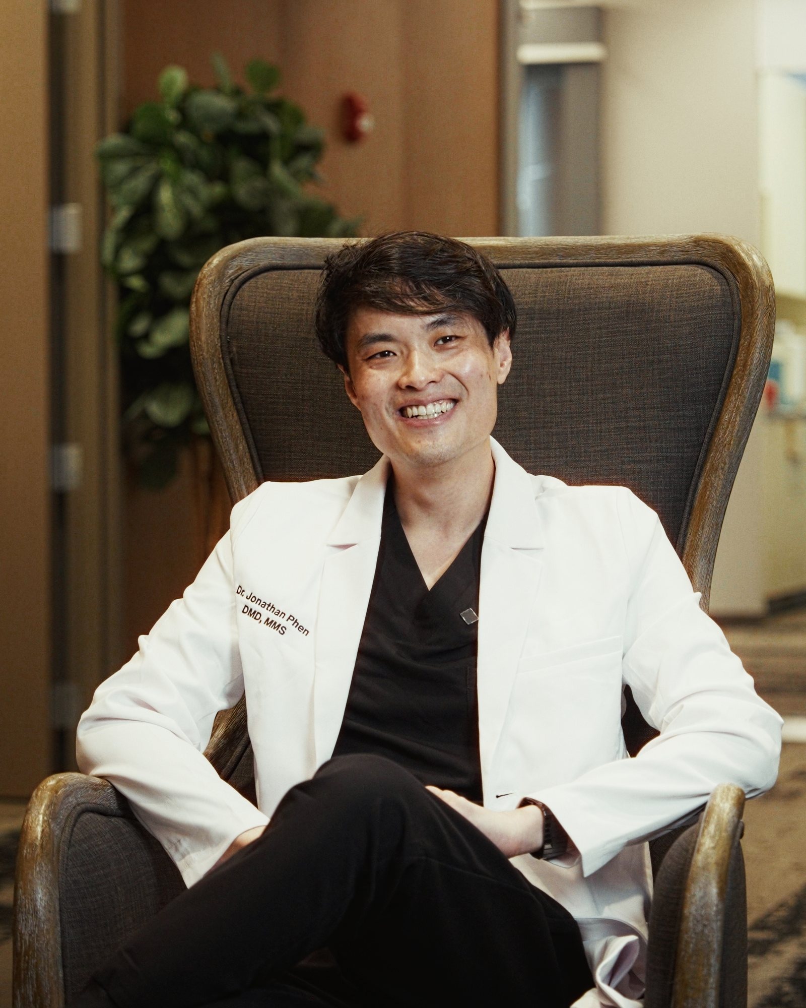 Dr. Jon Phen, seated, in his white coat