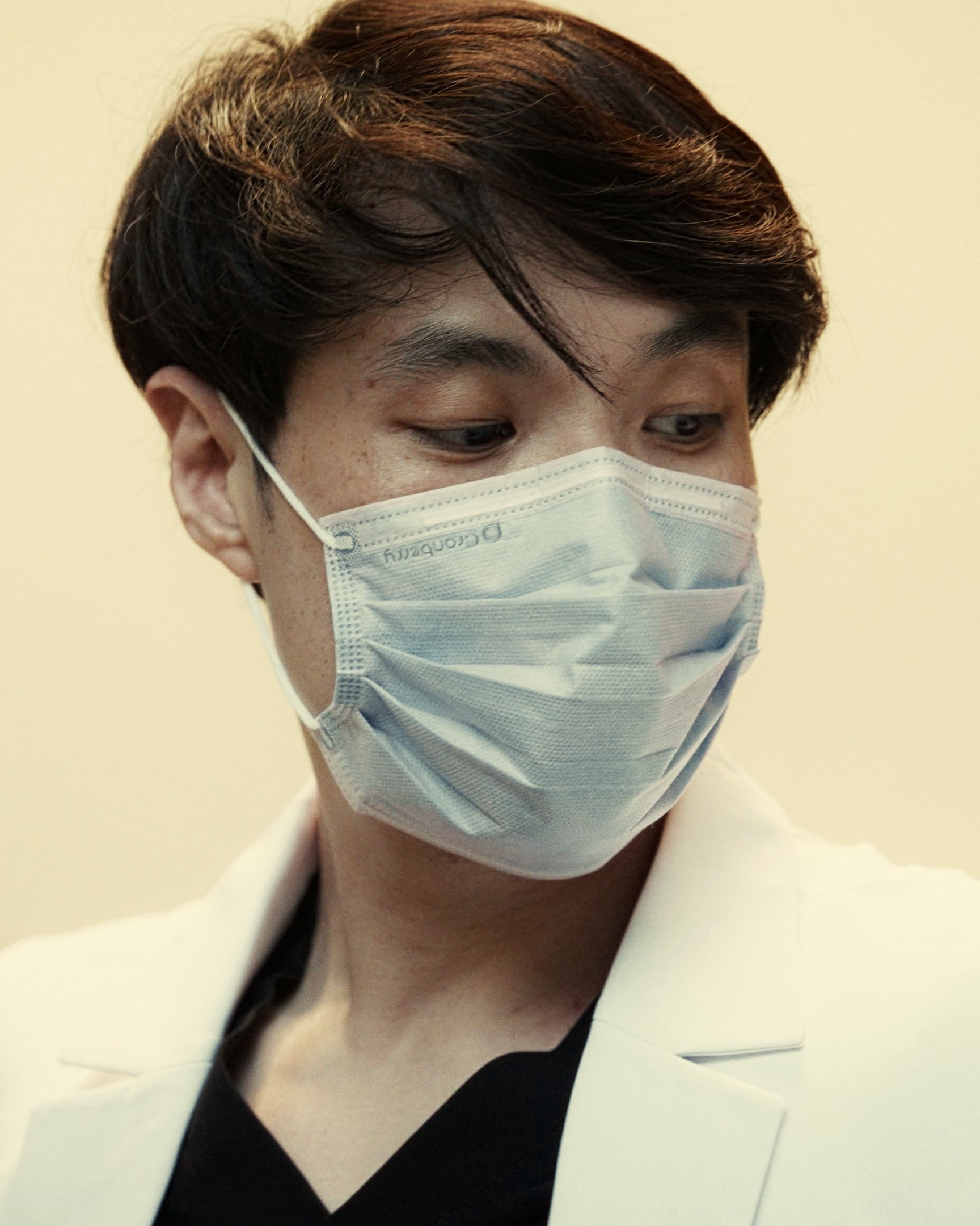 Dr. Phen at work, masked, looking down